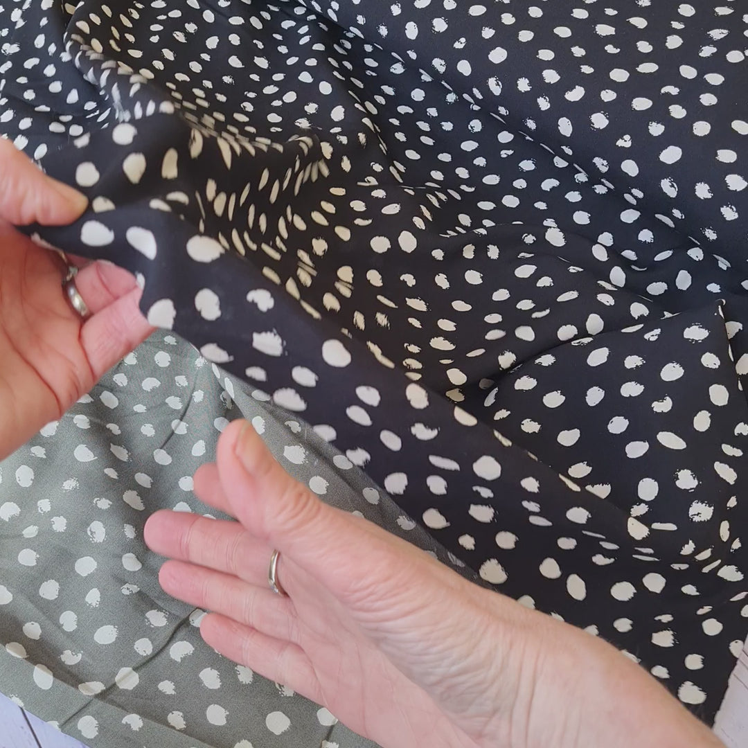 Random dots 100% Viscose Challis dress fabric by the half metre. Navy/green/black.