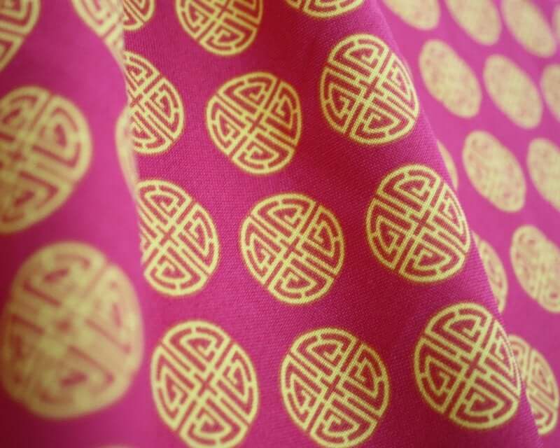 Chinese 'Lu' Prosperity Symbol Bi-Stretch Dress Fabric. By the metre. Cerise pink and charcoal grey.